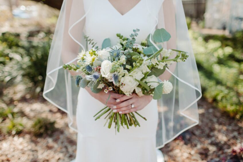 Wedding regret. Bride in a bridal gown holding a bouquet of flowers.