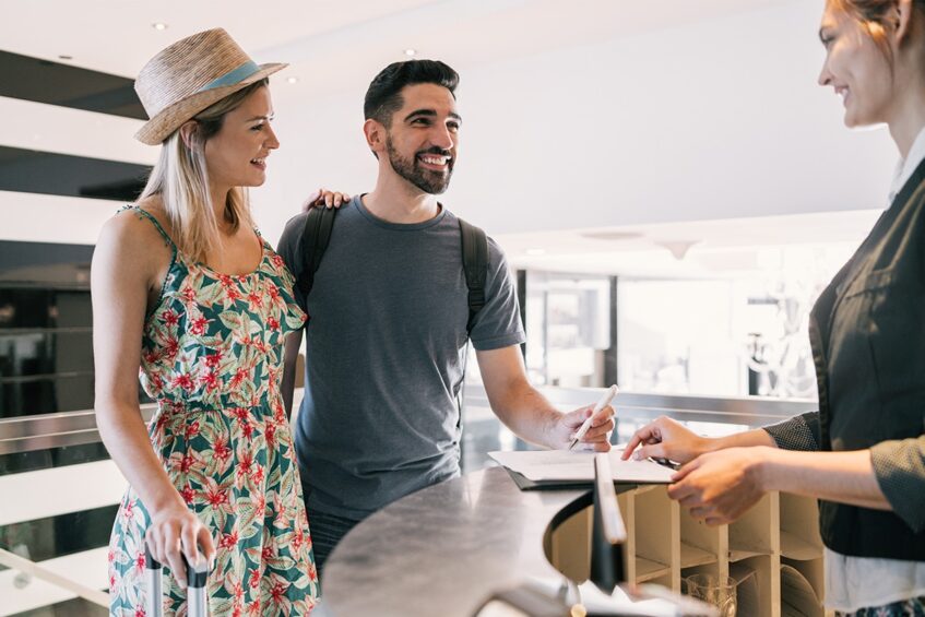 couple talking to a hotel clerk