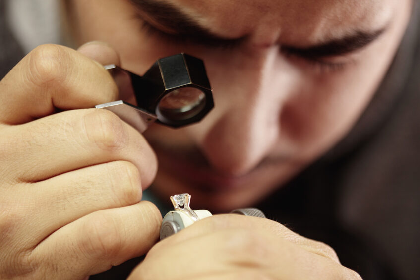 jeweler inspecting a diamond ring