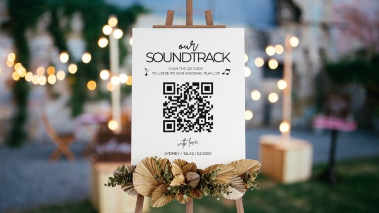 Wedding song request QR code sign on an easel at an outdoor reception