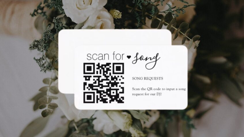 Song request QR card set beside white flowers
